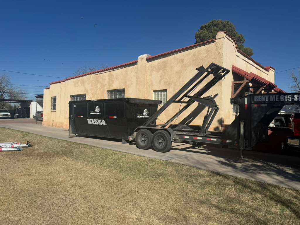 C&A Dumpster delivered on the side of a residential home